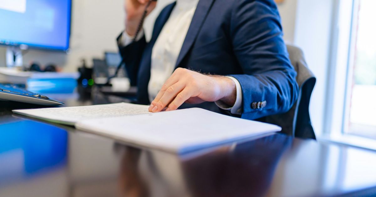 A business manager making a call from desk.