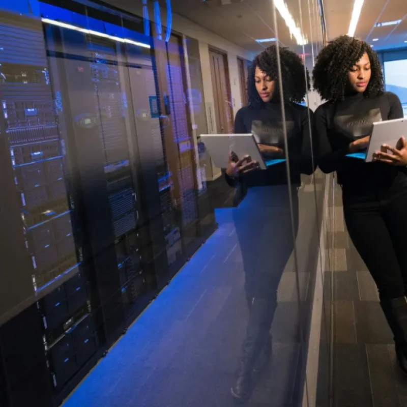 Network engineer standing in the server room with HVAC controlled environment.