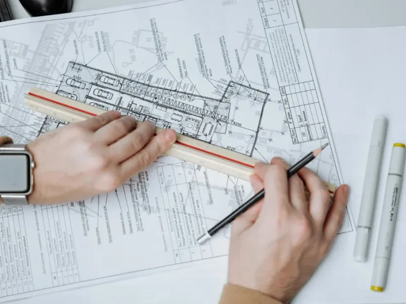 Mechanical contractors measuring blueprints.